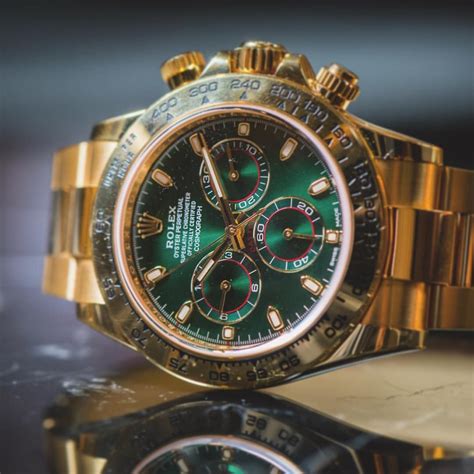 gold watch with green face rolex